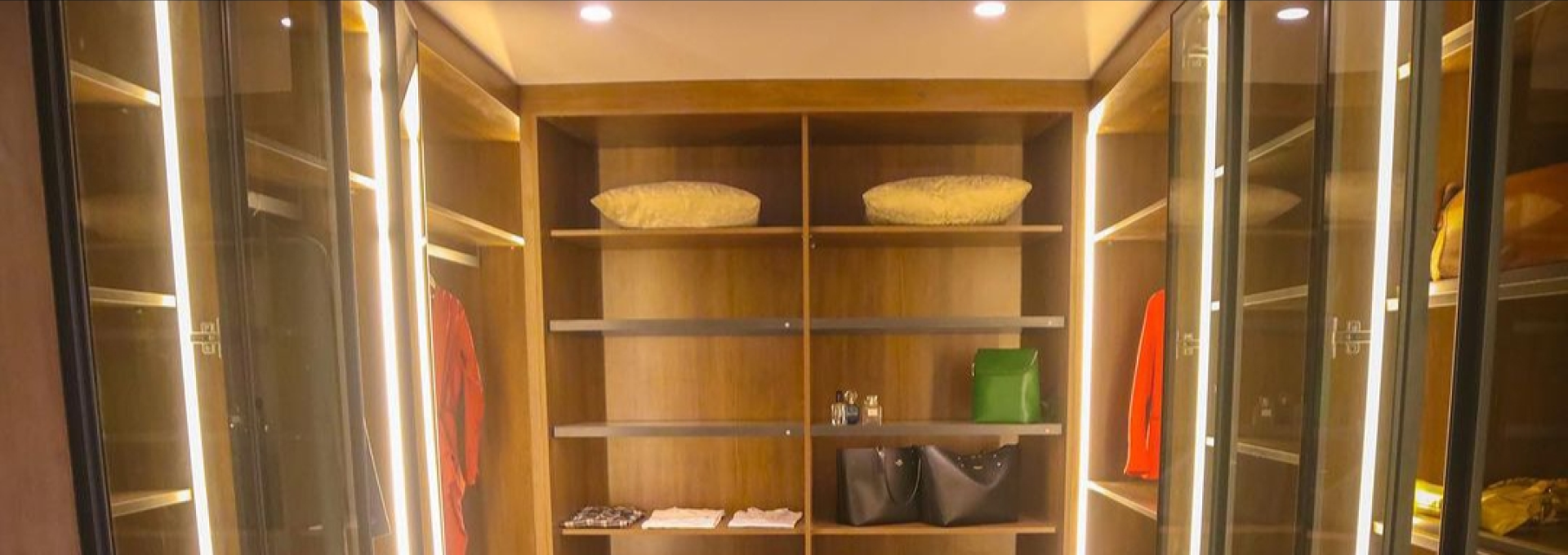 Modern L-shaped modular kitchen with charcoal grey cabinetry by Royal Dream Interior